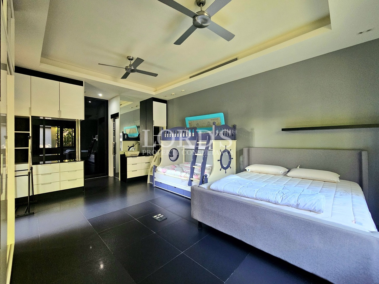 Spacious family bedroom with built-in storage and bunk bed