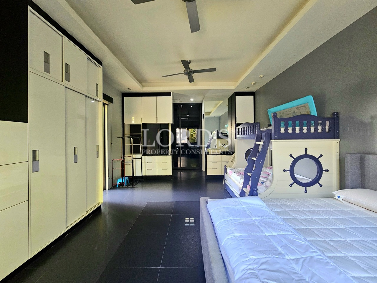 Spacious family bedroom with built-in wardrobes and custom bunk bed