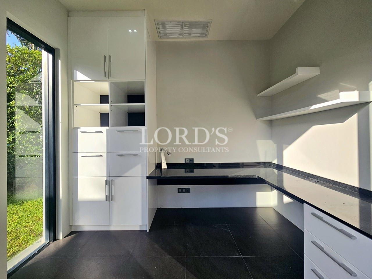 Modern home office with built-in cabinetry and workspace