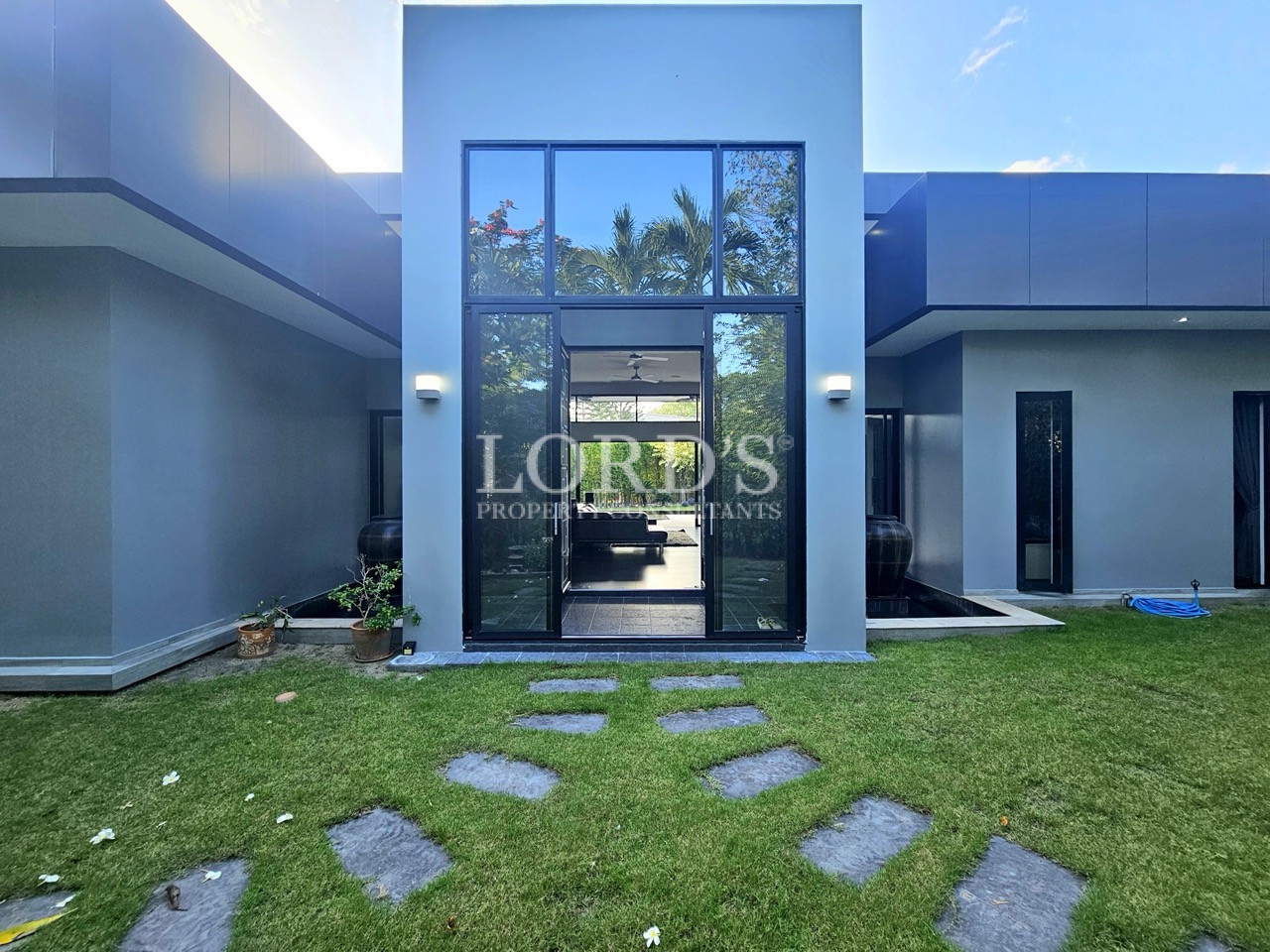 Modern luxury villa with floor-to-ceiling glass entrance