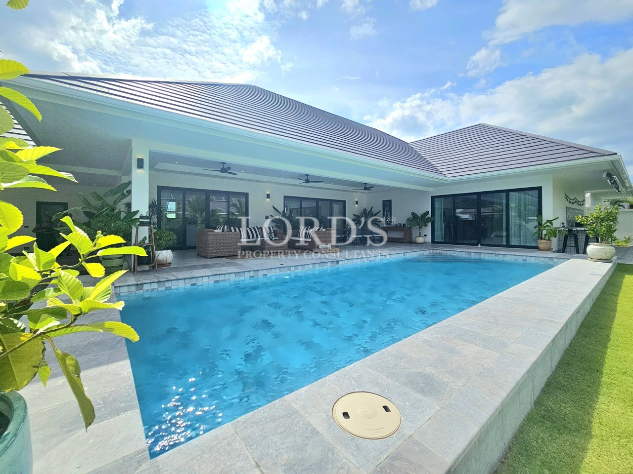 Modern villa with private swimming pool, covered patio, and landscaped garden