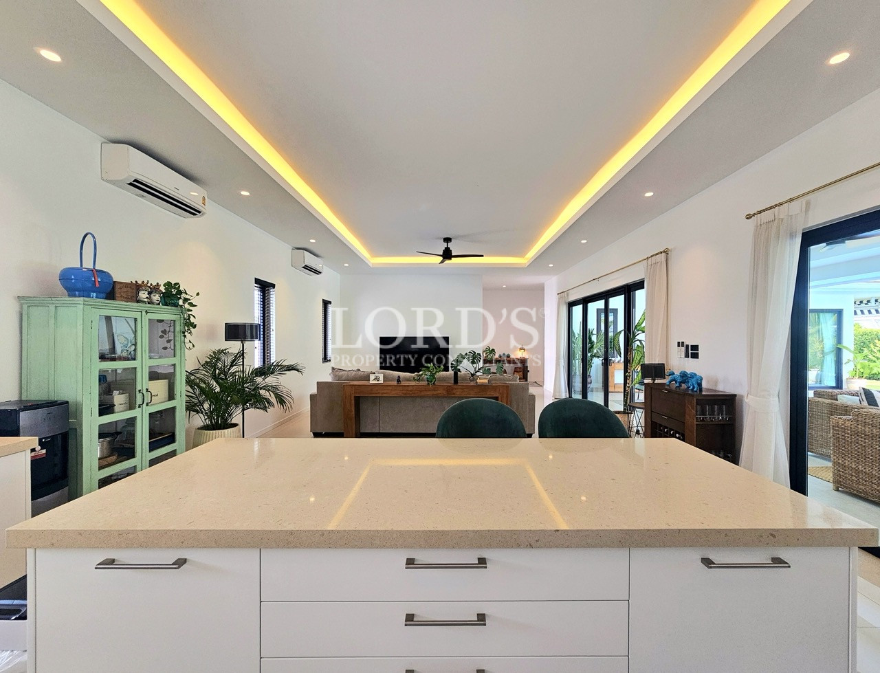 Modern open-plan kitchen and living room with large island and sliding glass doors