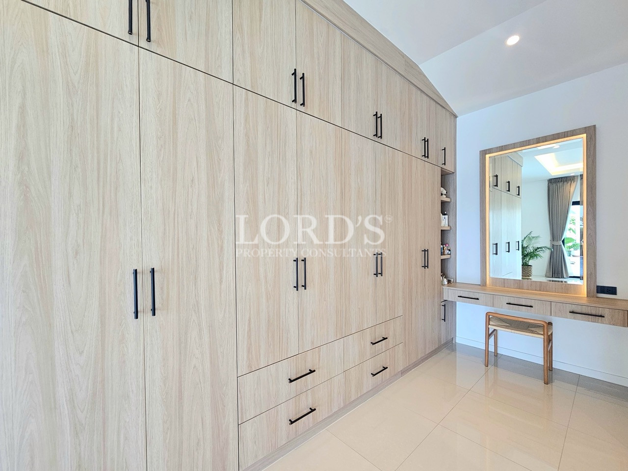 Modern built-in wardrobe with dressing table and large mirror