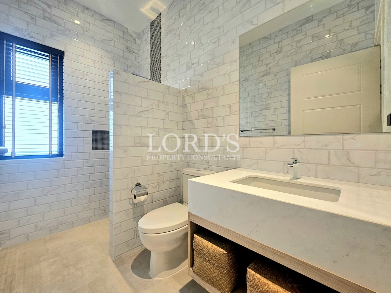 Modern bathroom with walk-in shower, floating vanity, and large mirror