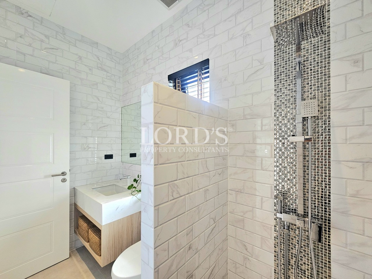 Modern bathroom with glass-enclosed shower and wooden vanity