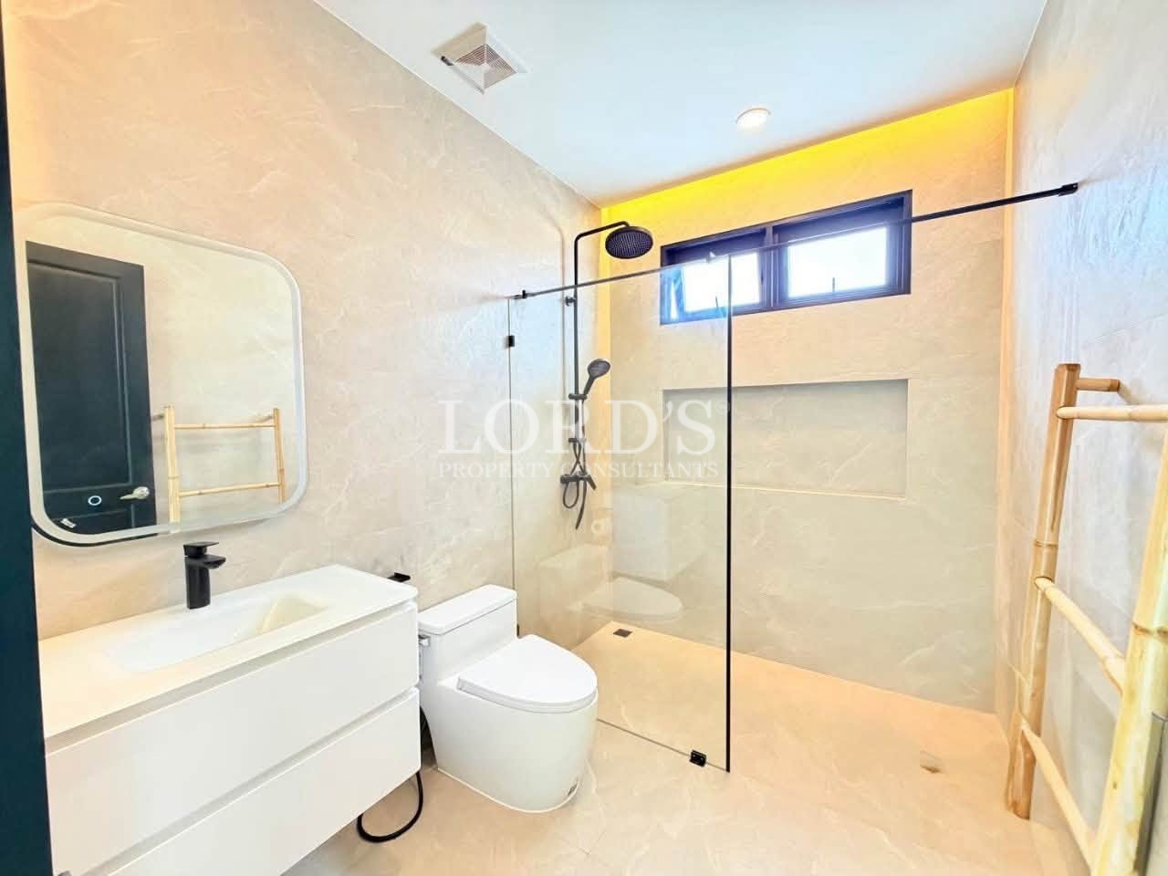 Modern luxury bathroom with a glass-enclosed walk-in shower and double vanity