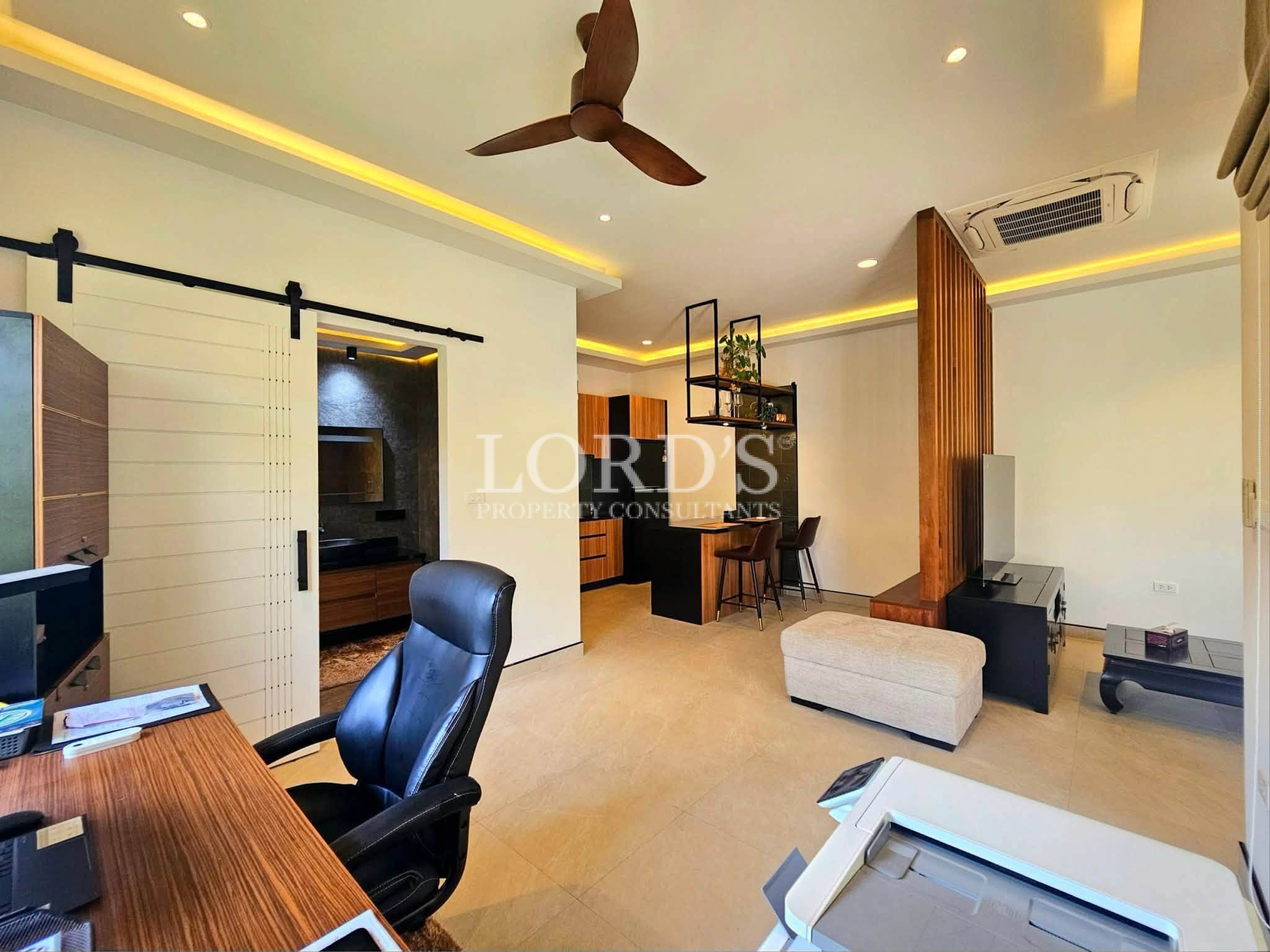 Modern home office and entertainment room with workspace, media area, breakfast bar, and contemporary wood accents