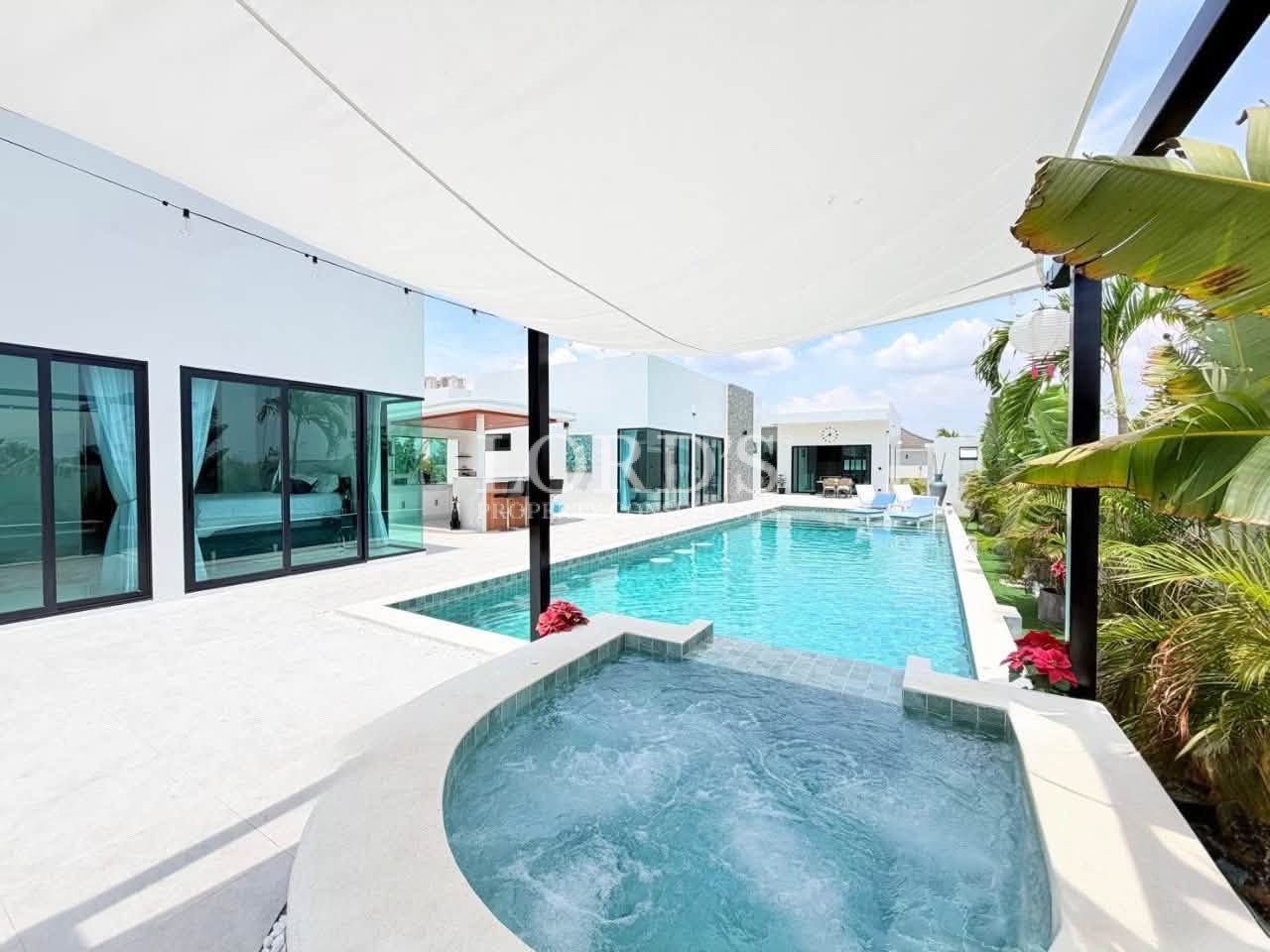 Modern private swimming pool with spa and outdoor patio