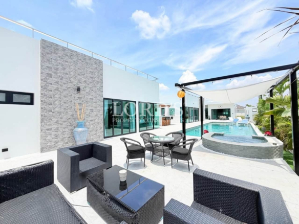 Modern outdoor patio with swimming pool and lounge seating