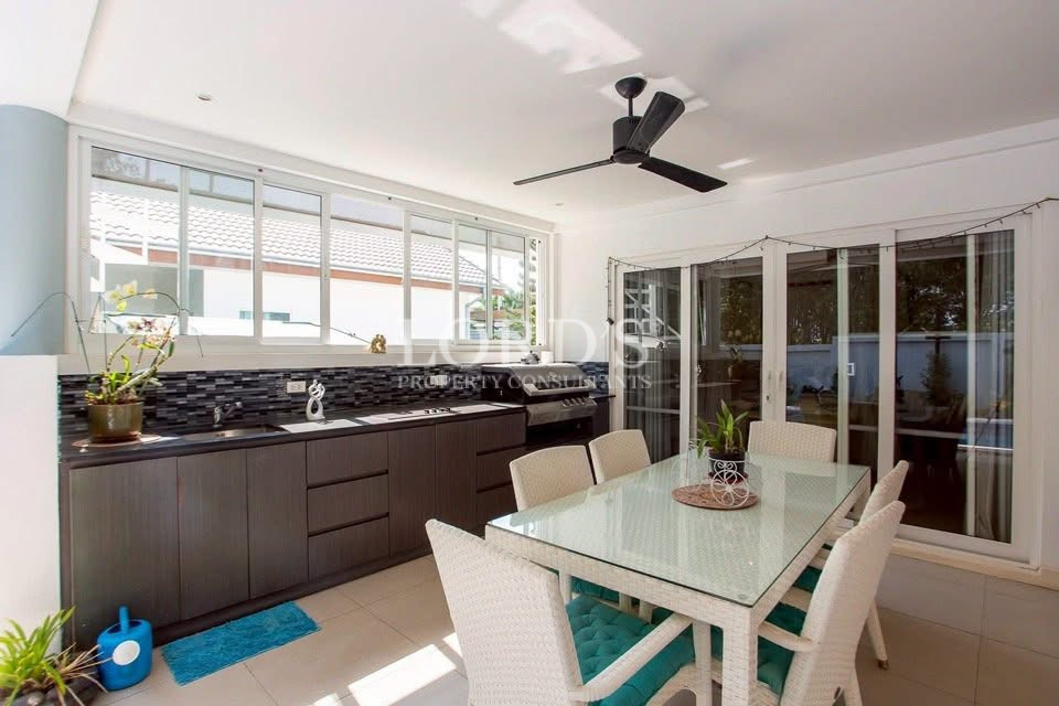 Bright kitchen and dining area with modern cabinets and glass doors