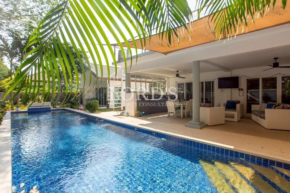 Private swimming pool with covered outdoor living and dining area