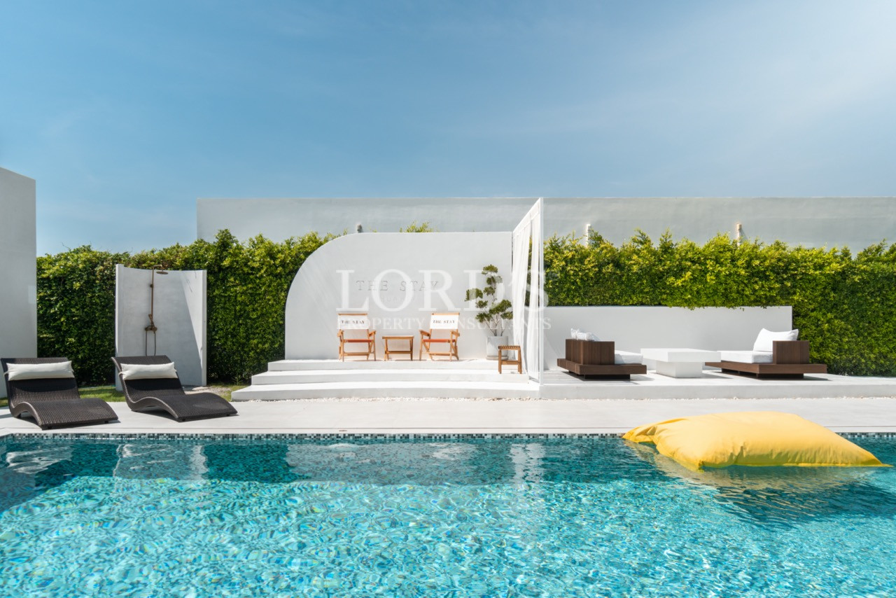 Modern private pool with sun loungers and outdoor seating area