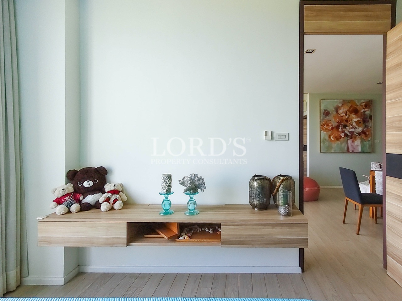 Modern apartment bedroom with floating wooden console, decorative accents, and contemporary minimalist interior