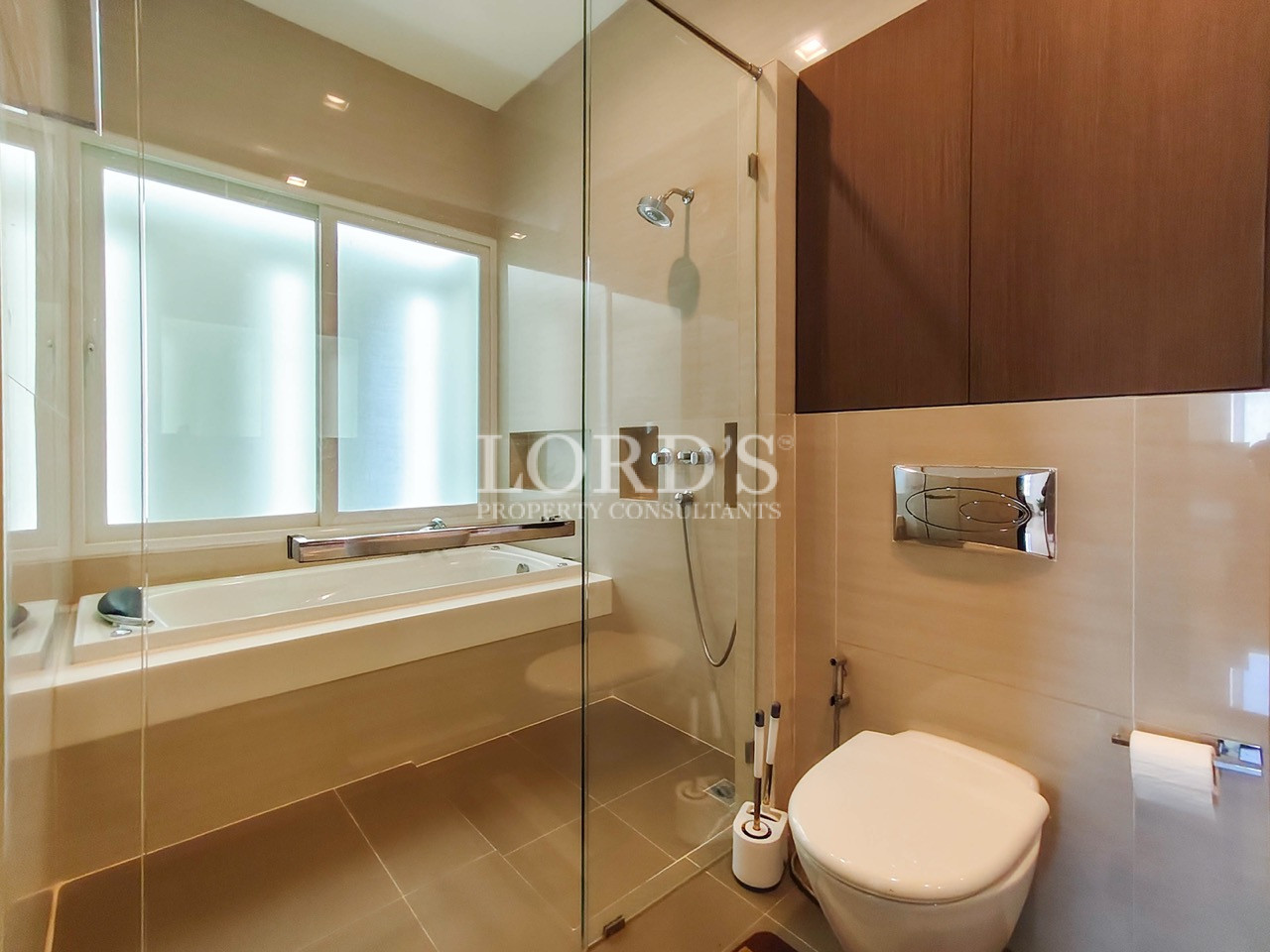 Luxury bathroom with freestanding bathtub, glass walk-in shower, wall-mounted toilet, and modern design