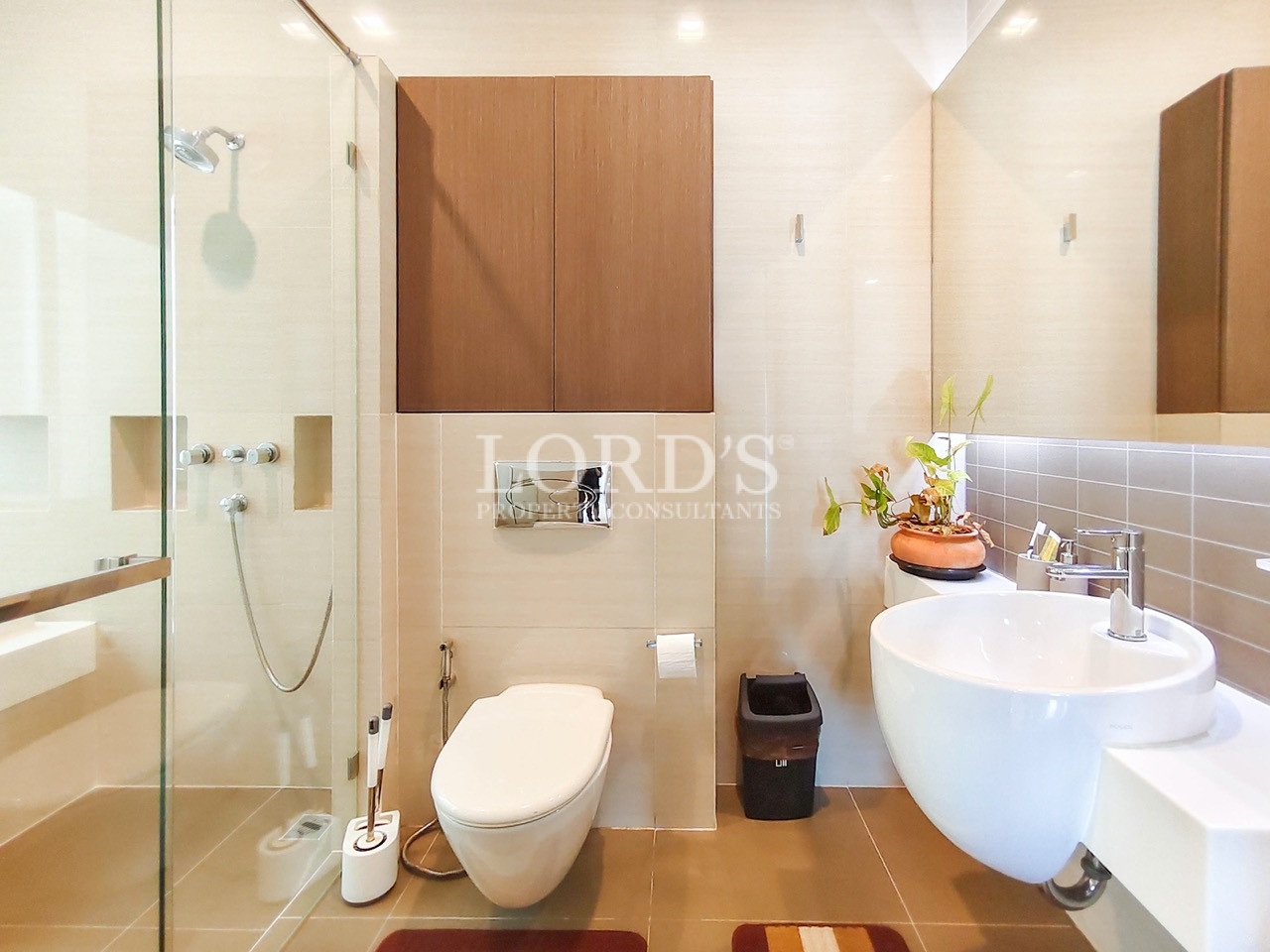 Luxury modern bathroom with glass walk-in shower, vessel sink, floating vanity, and contemporary fixtures