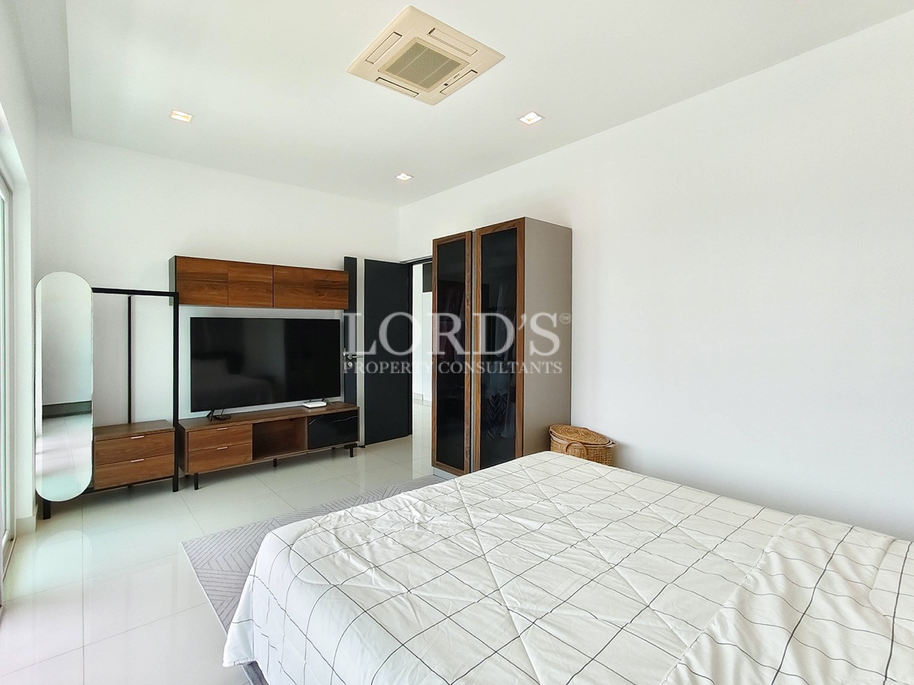 Luxury modern bedroom with TV unit, wardrobe, king-size bed, and minimalist interior design