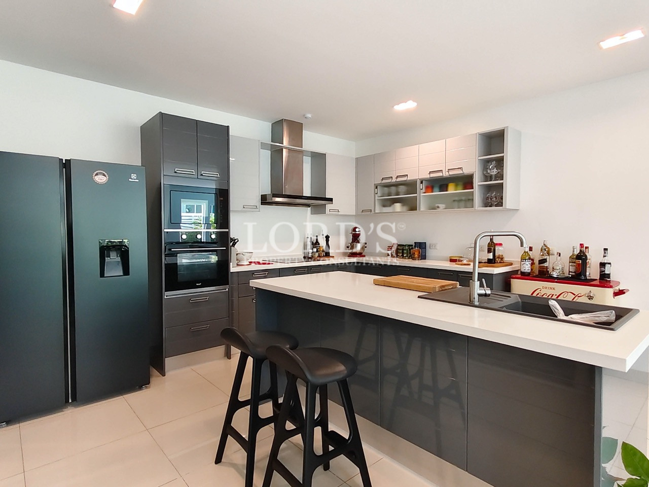 Modern luxury kitchen with island, built-in appliances, and contemporary cabinetry