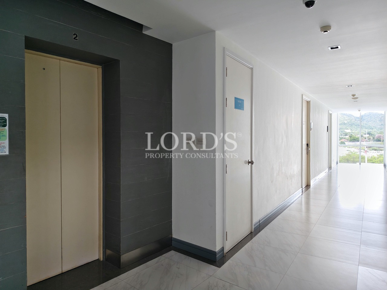 Modern apartment building hallway with elevator and tiled floor