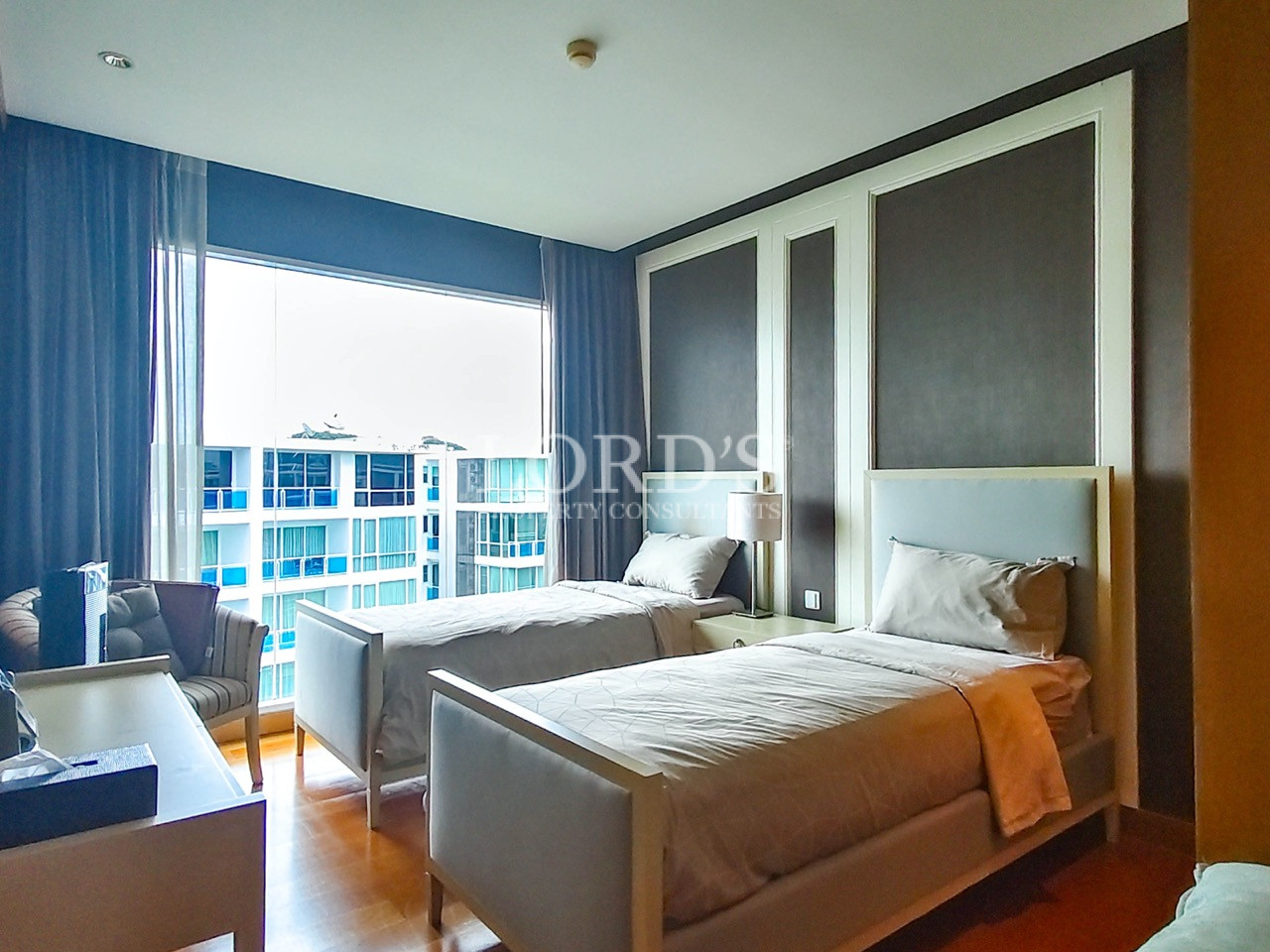 Modern twin bedroom with two single beds and large window
