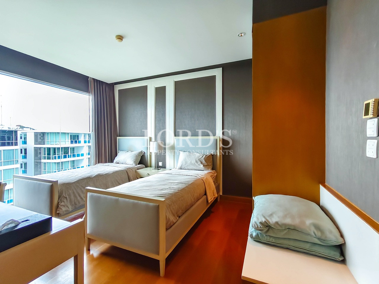 Modern twin bedroom with large windows and city view