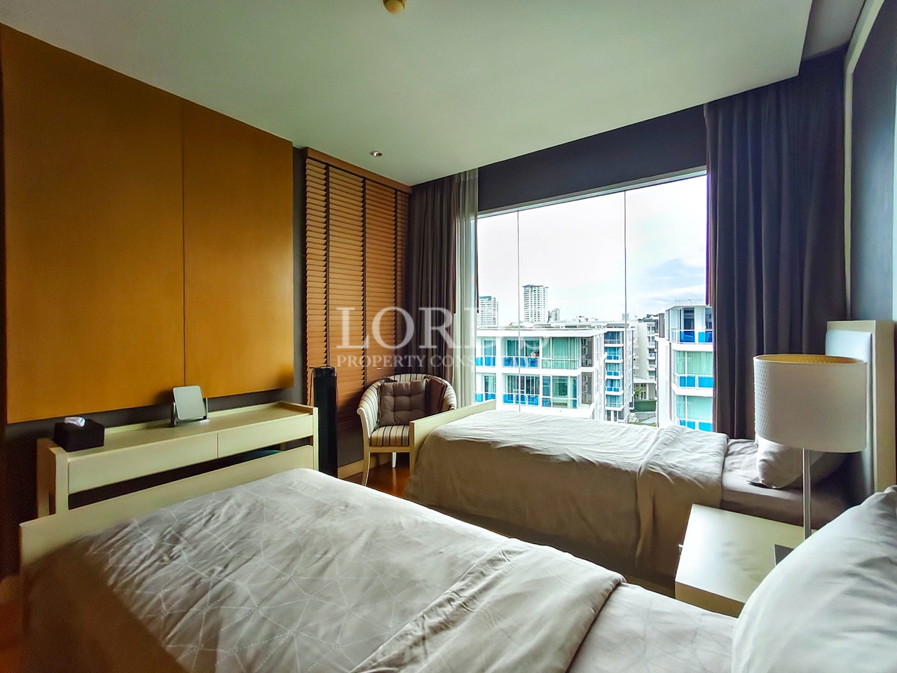 Modern twin bedroom with panoramic city view and large windows