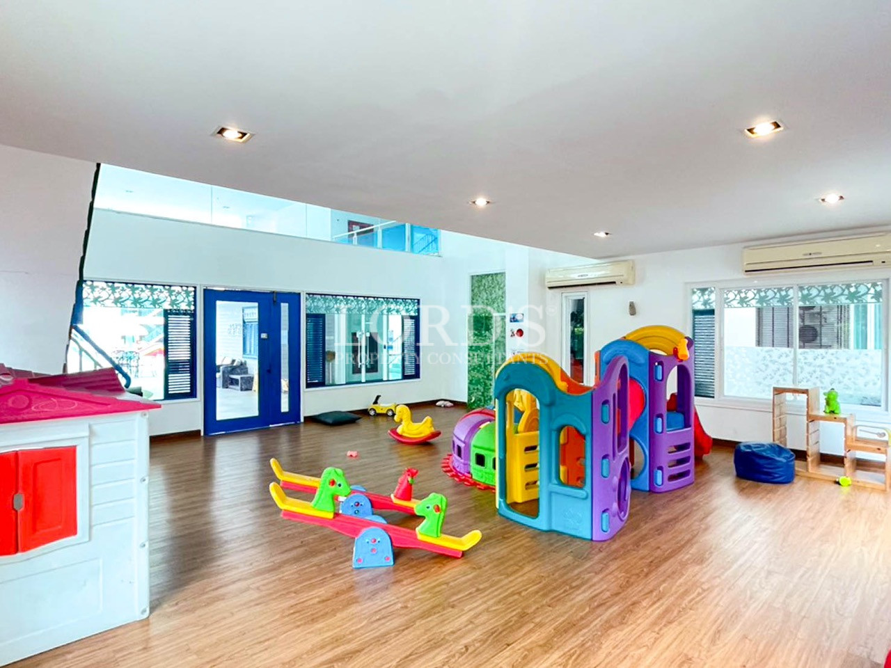Colorful indoor children’s play area with slides and rocking toys