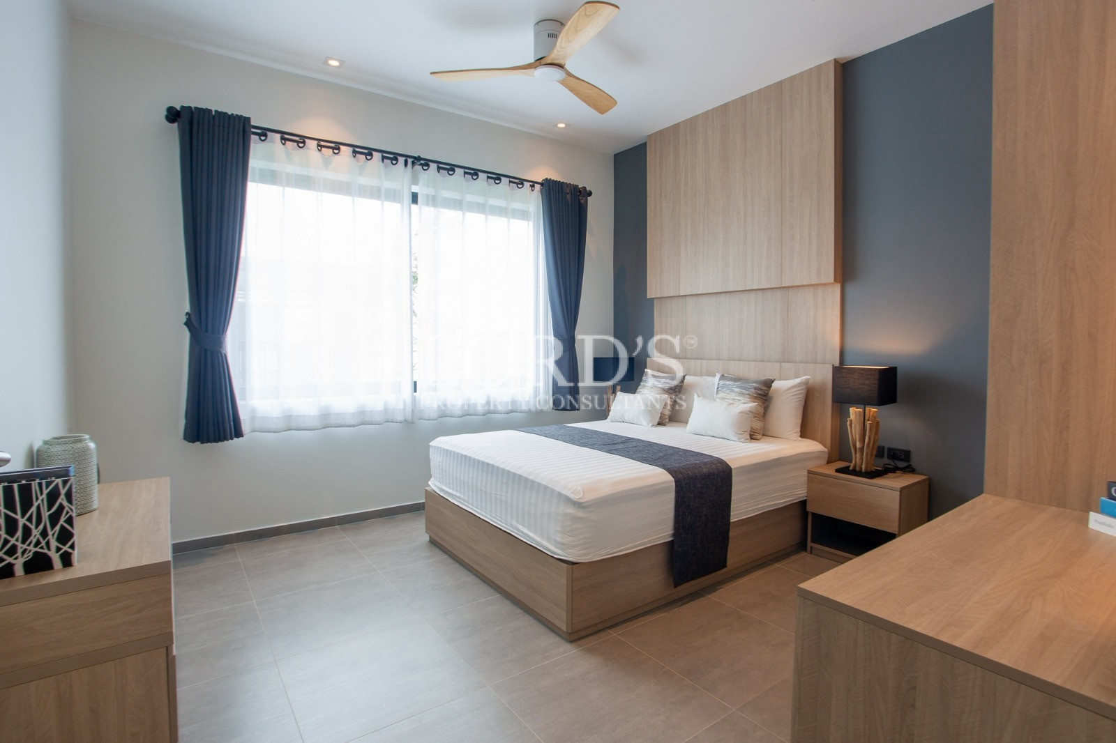 Modern minimalist bedroom with wooden feature wall and large window