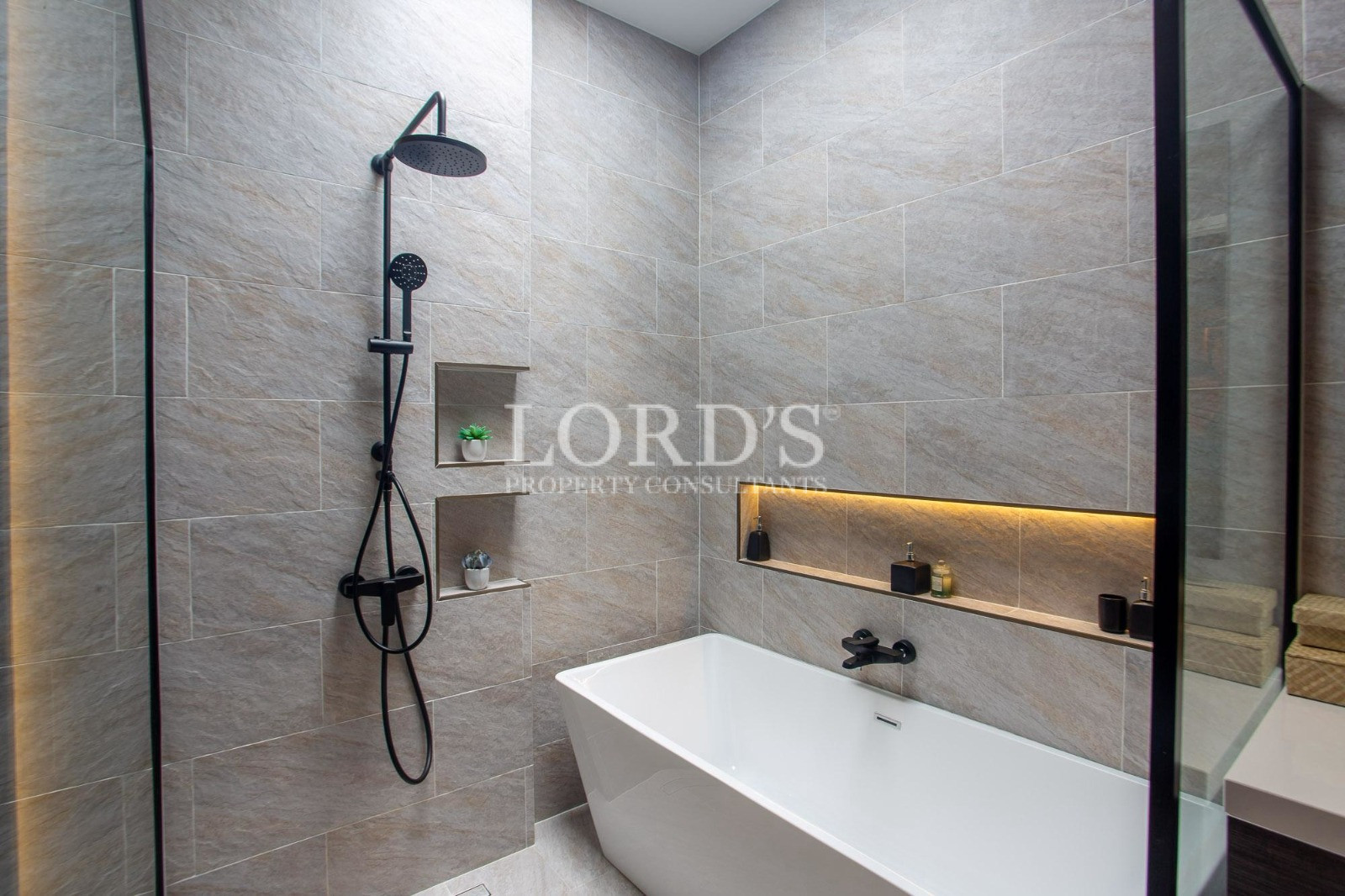 Modern luxury bathroom with freestanding bathtub and rainfall shower
