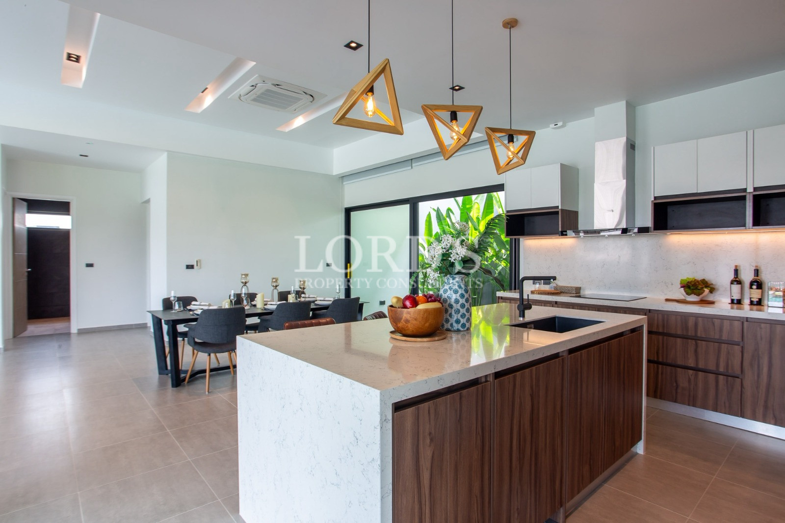 Modern open-plan kitchen with dining area and marble island