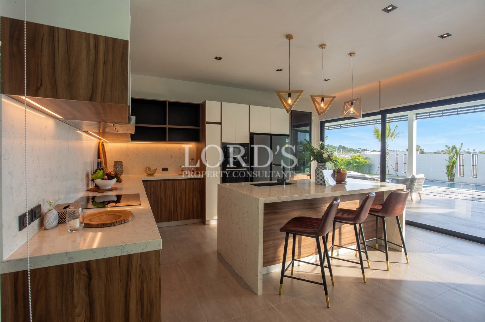 Modern luxury kitchen with island and pool view