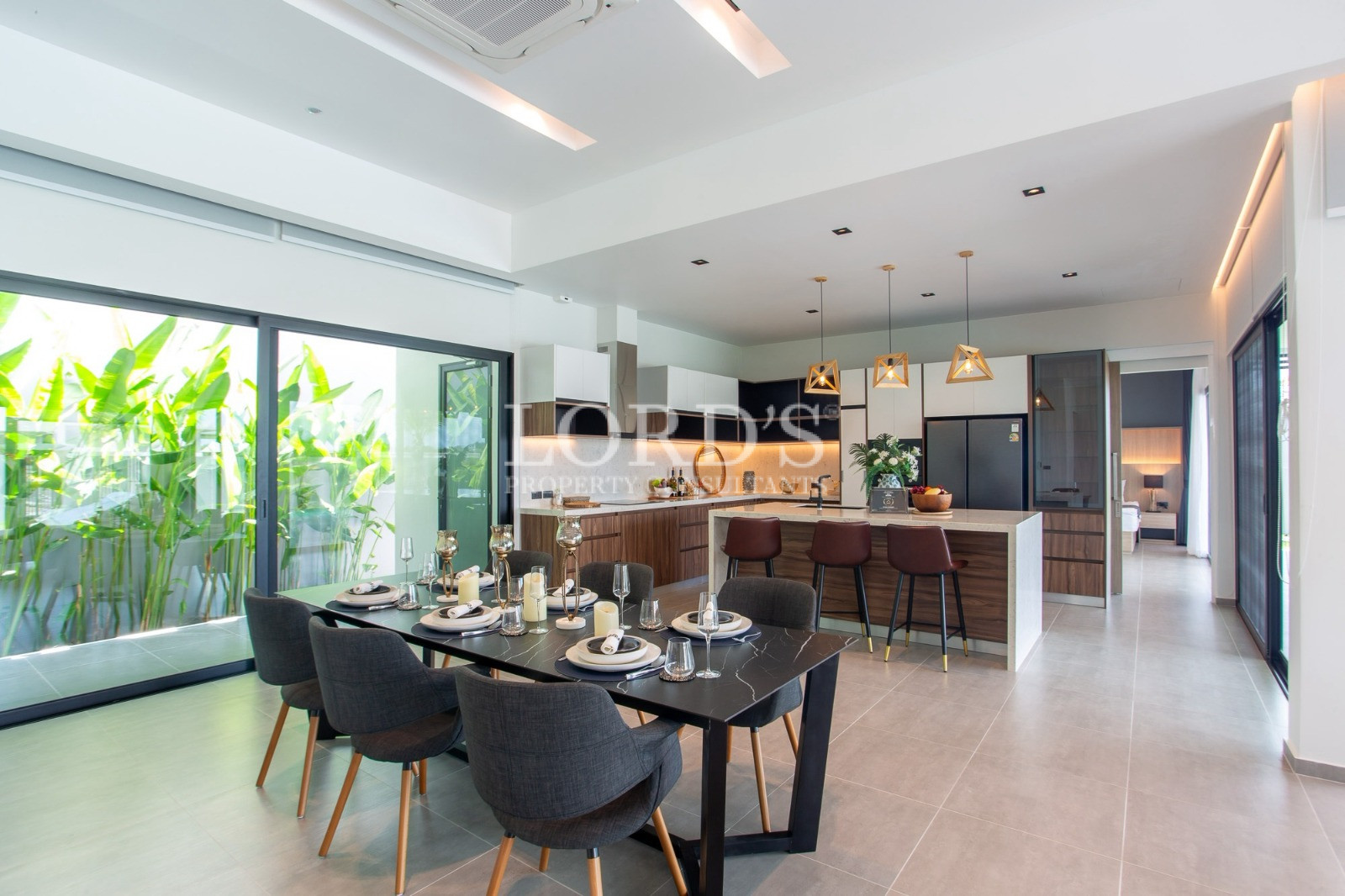 Modern open-plan kitchen and dining area with garden view