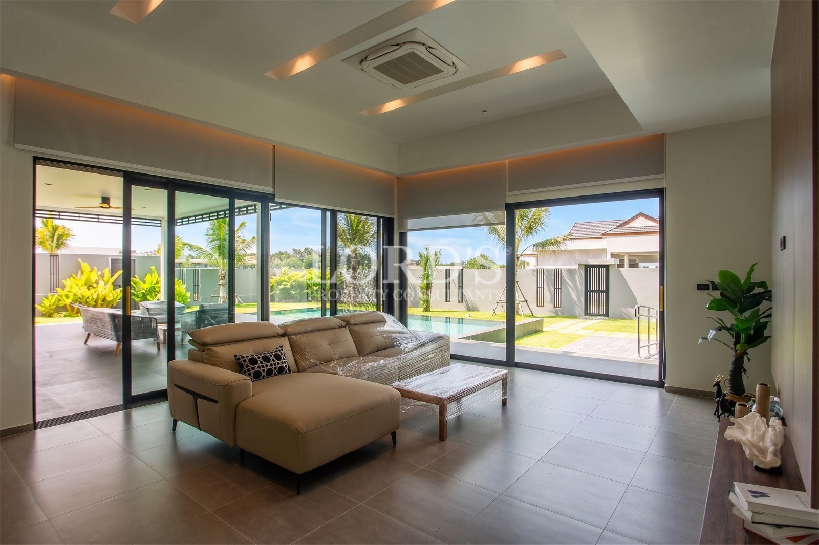 Modern luxury living room with pool view and floor-to-ceiling windows