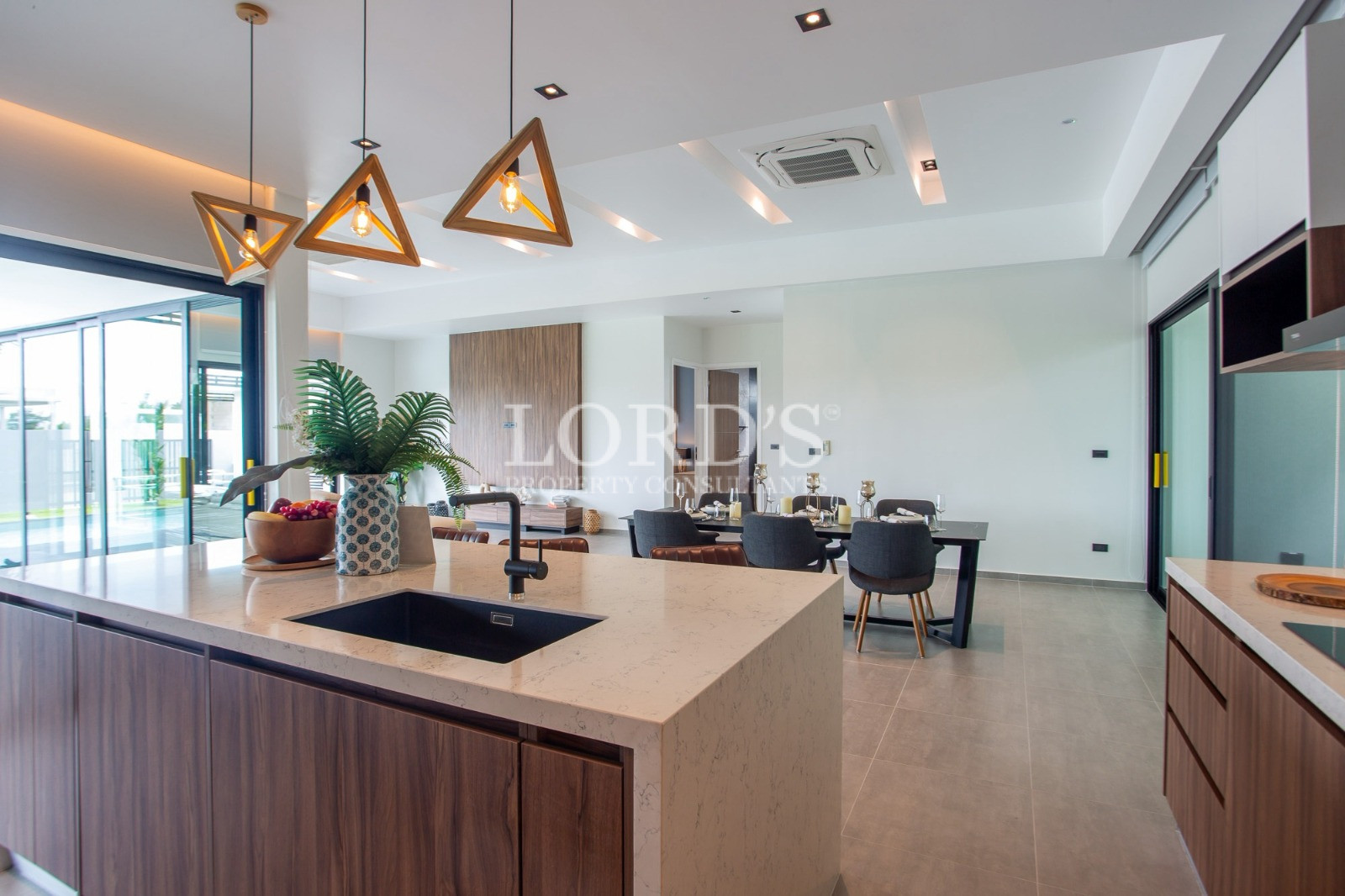 Modern luxury kitchen and dining area with large island and pendant lights