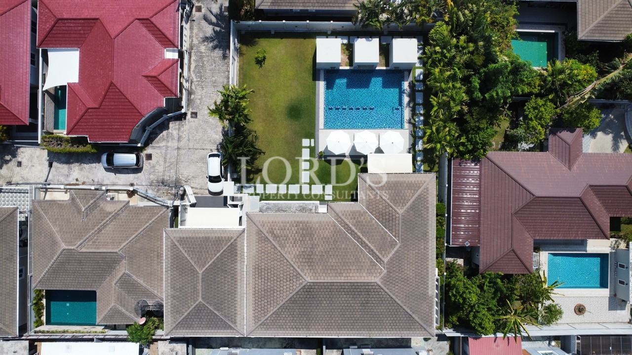 Top-down aerial view of luxury villa with pool