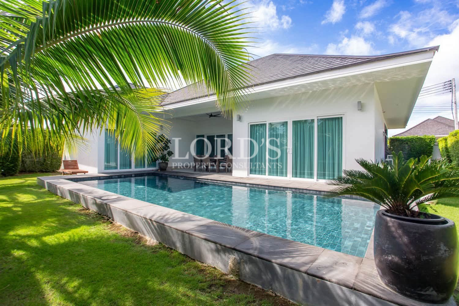 10 Private swimming pool surrounded by tropical greenery and a modern villa
